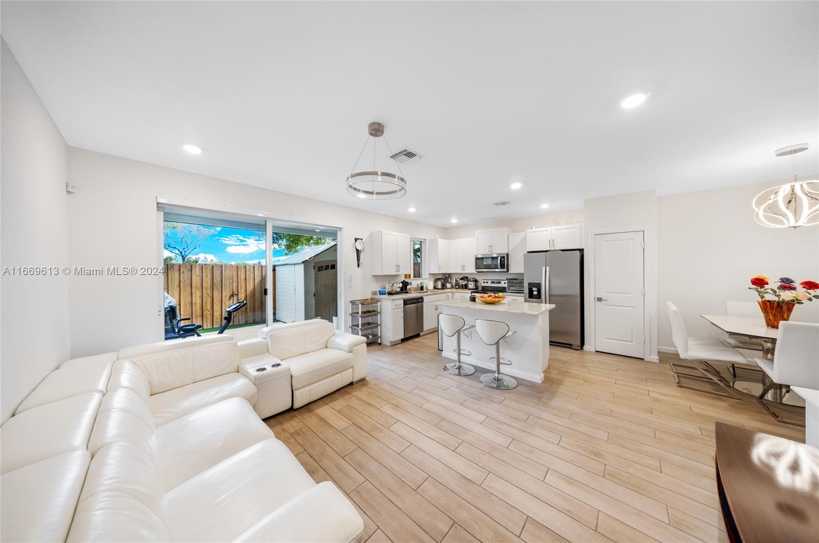 a living room with furniture and kitchen view