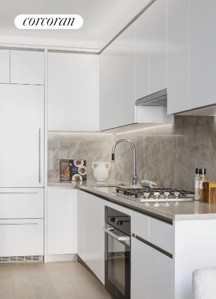 a kitchen with stainless steel appliances granite countertop a sink and cabinets