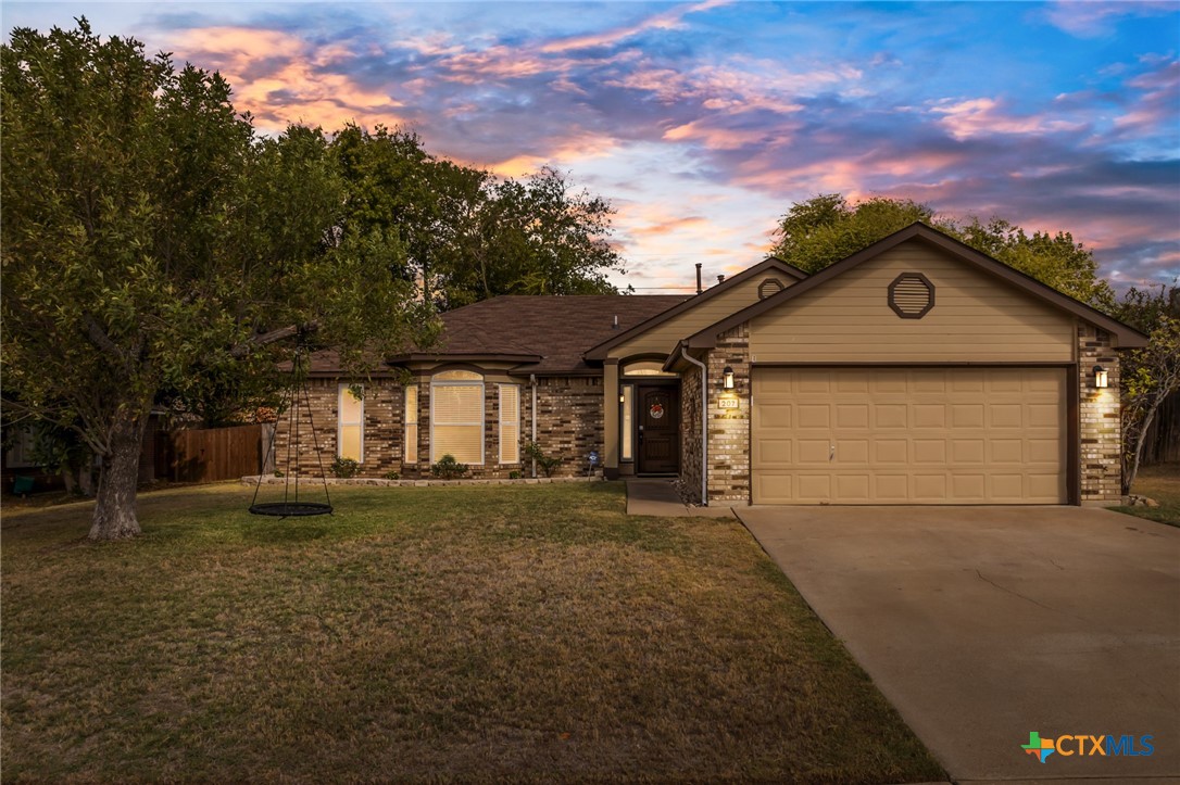 a front view of a house with a yard and garage