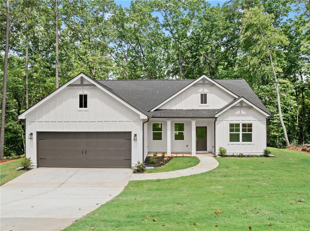 a front view of house with yard and green space