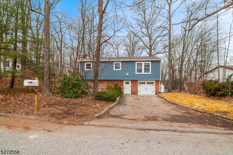 a front view of a house with yard and trees