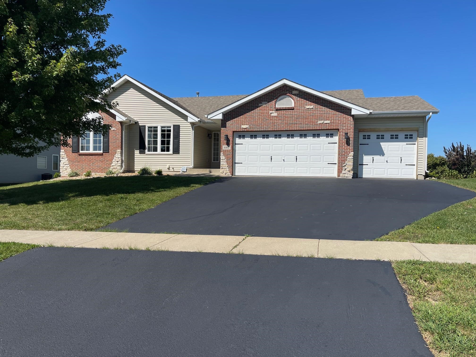 a view of a house with a yard and garage