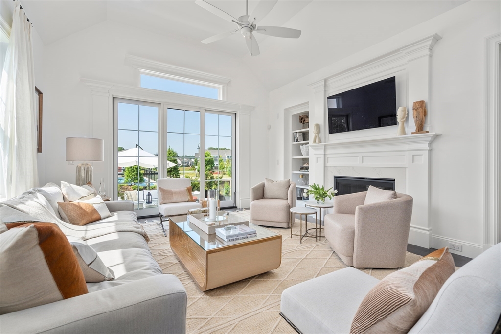 a living room with furniture fireplace and flat screen tv