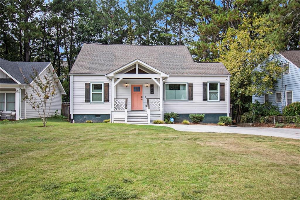 a front view of a house with a garden