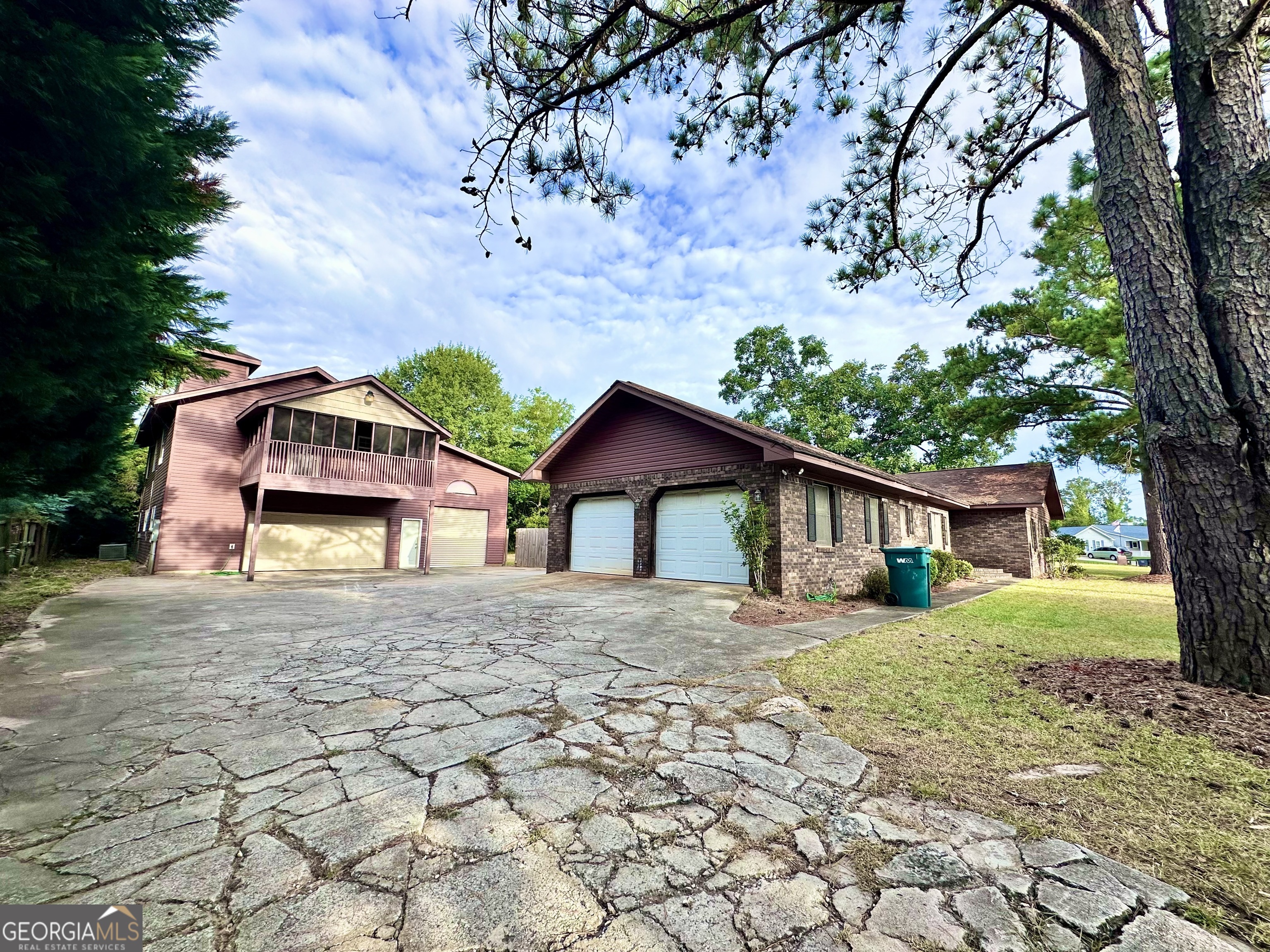 a front view of a house with a yard and trees