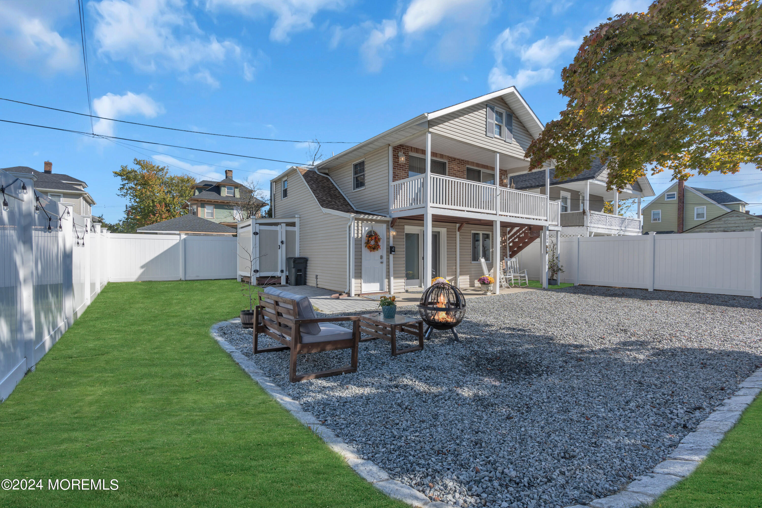 a view of a house with a yard and sitting area