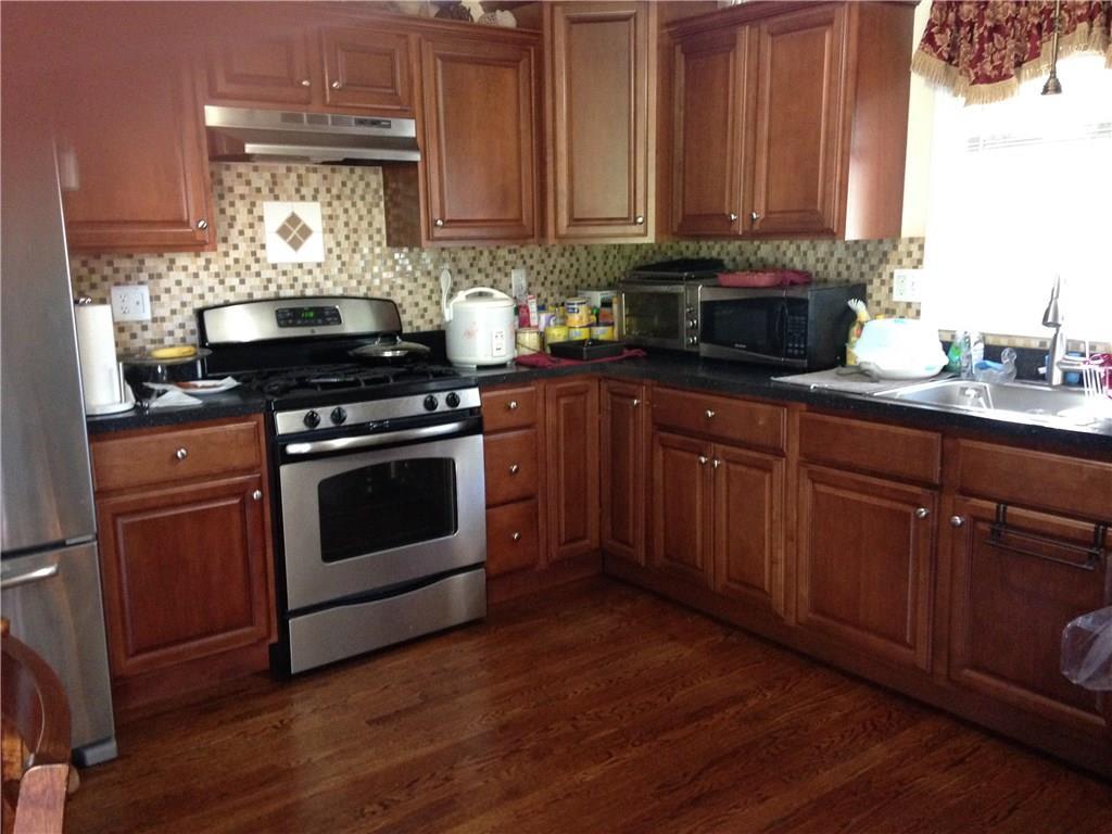 a kitchen with a stove a sink and a microwave