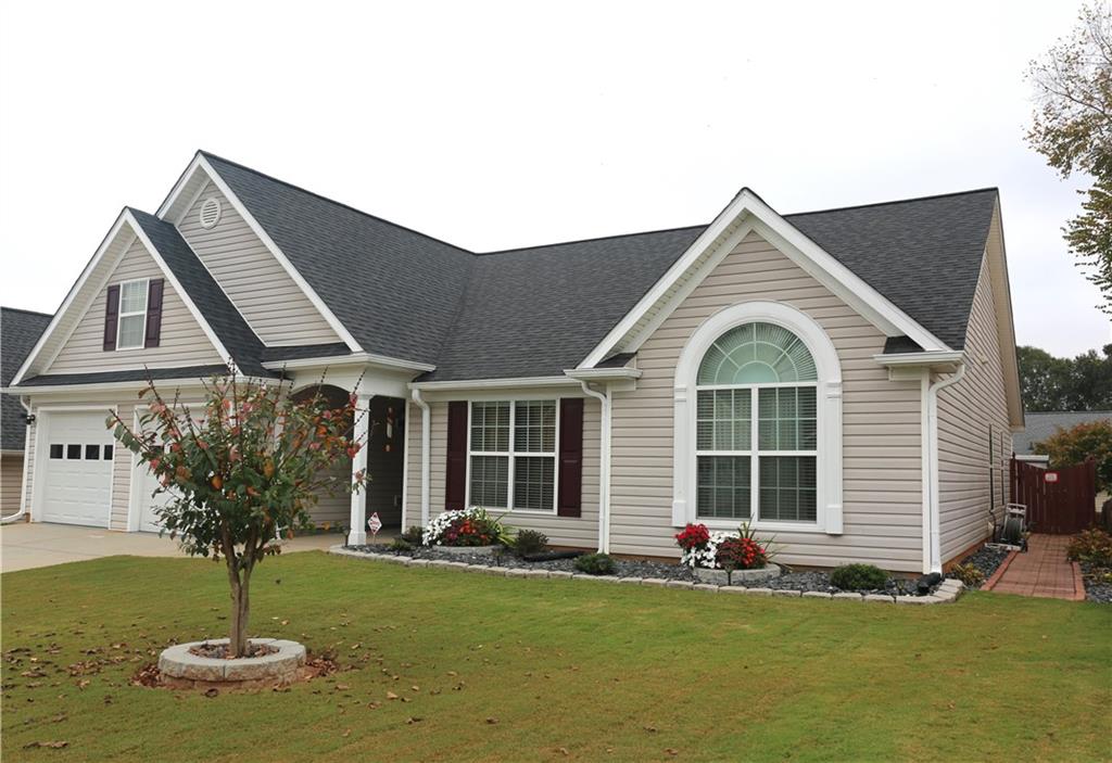 a front view of a house with a garden