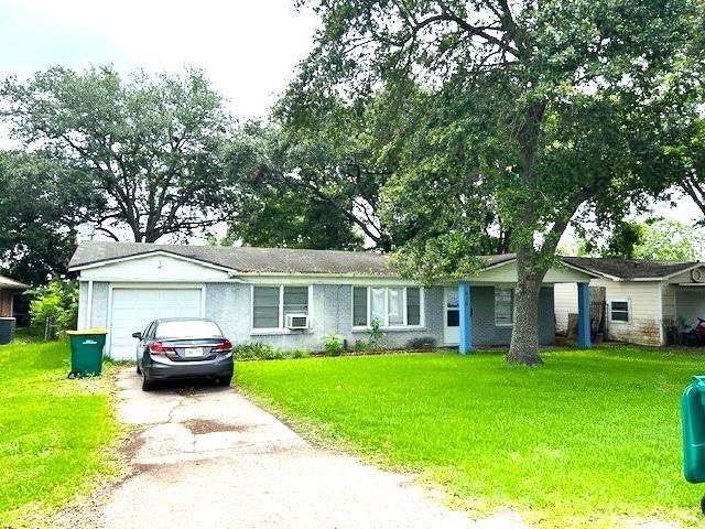 a front view of a house with a garden and trees