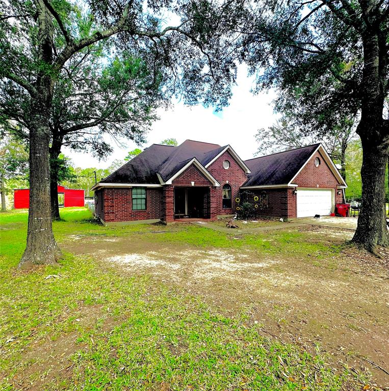 a front view of house with yard and garage