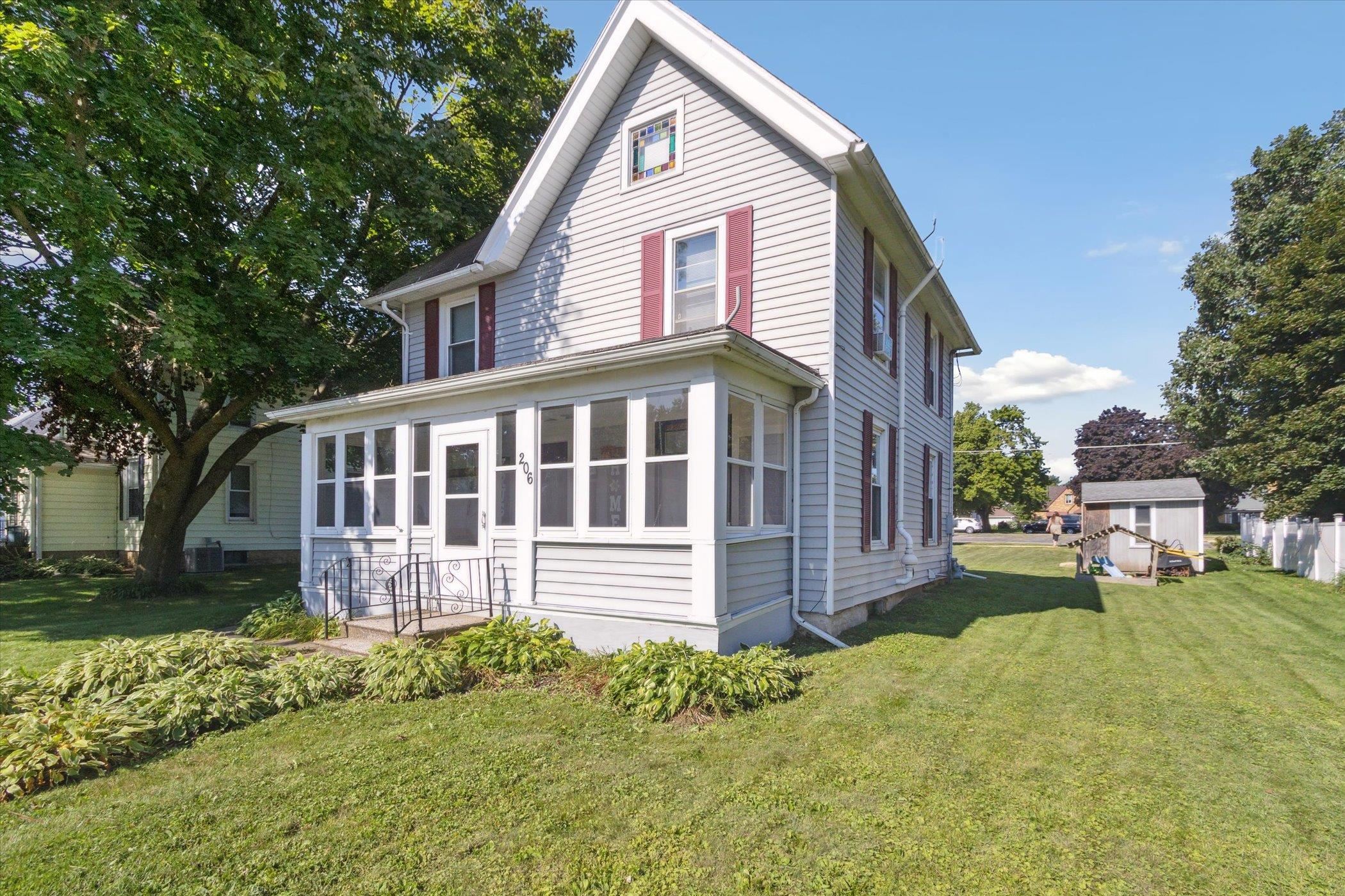 a front view of a house with a yard and porch