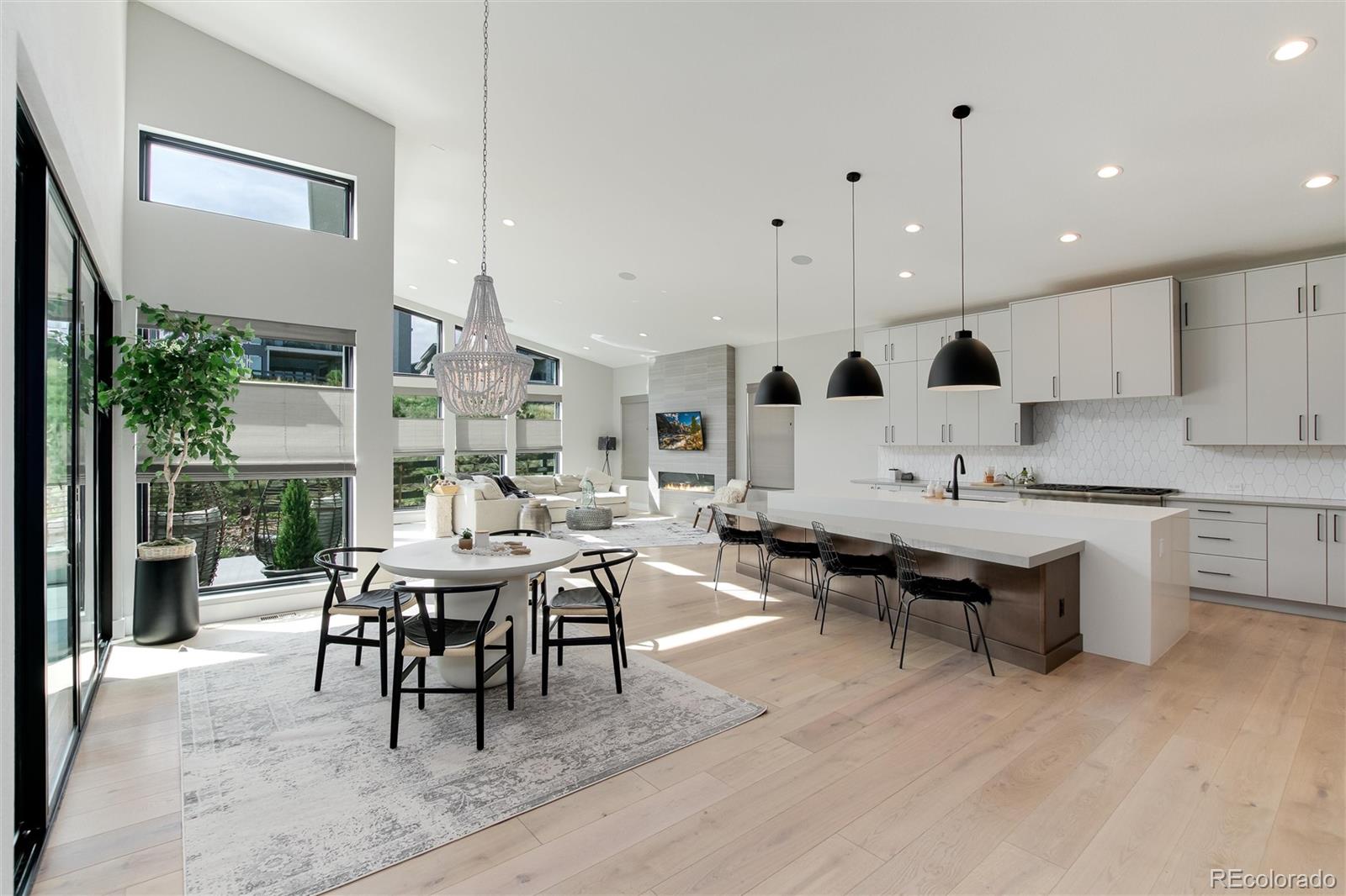 a view of kitchen with stainless steel appliances granite countertop dining table chairs and window