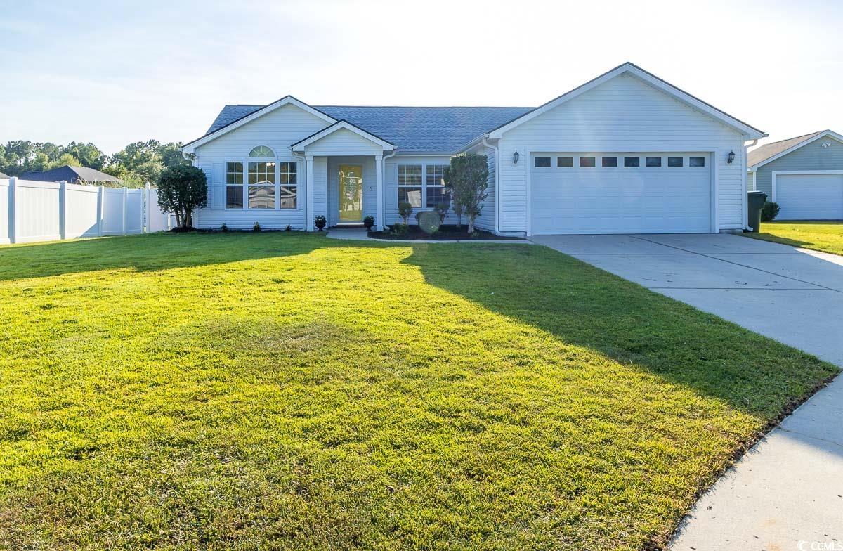 Single story home featuring a garage and a front l