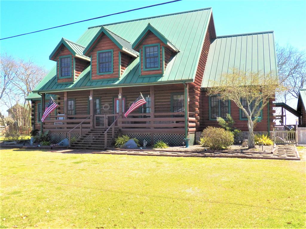 Welcome to this beautiful Log Ca Cabin Home on Trinity Bay, built on-site by The Original Old Timer Log Cabin & Supply, Inc.