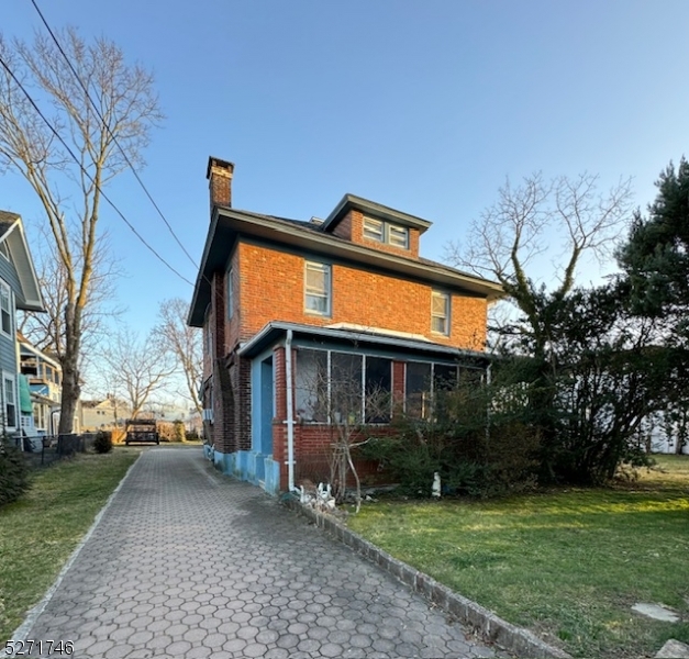 a view of house with a yard