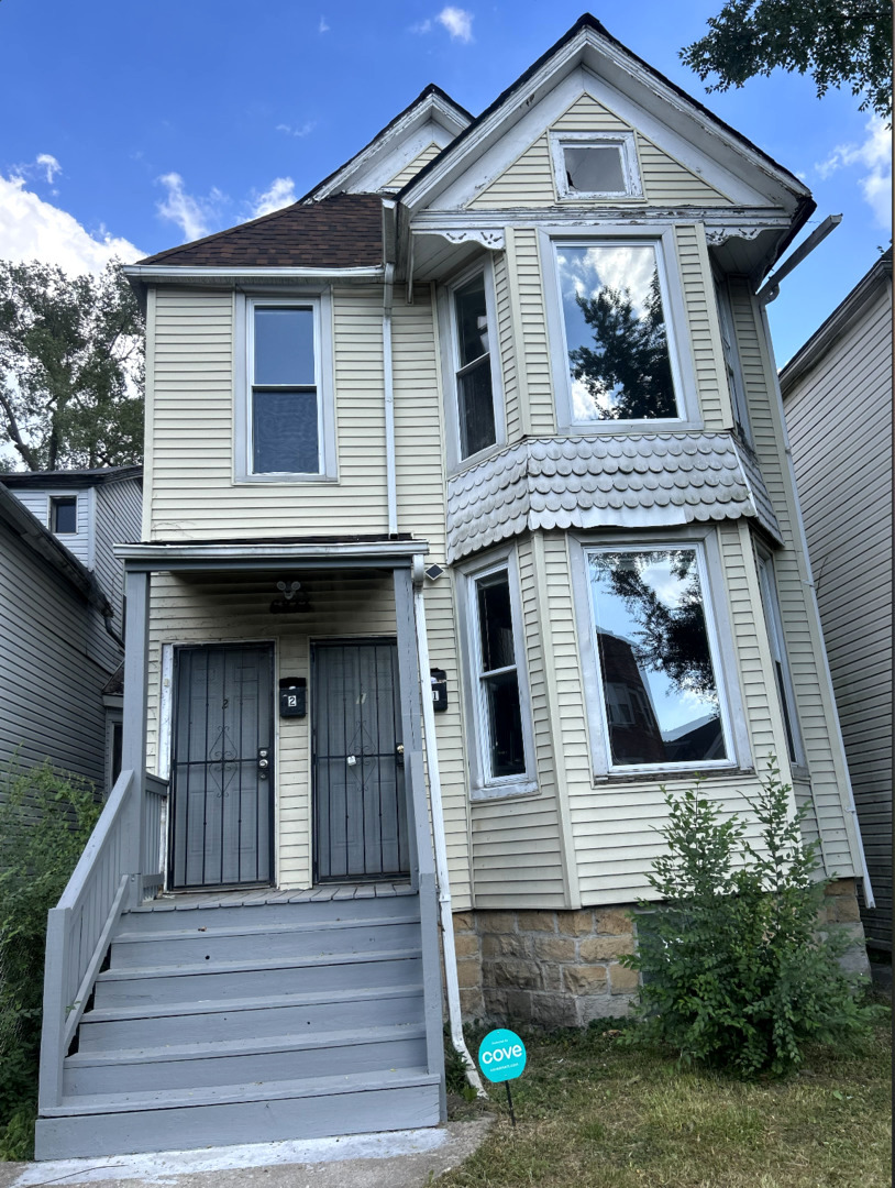 a front view of a house with a garden and plants