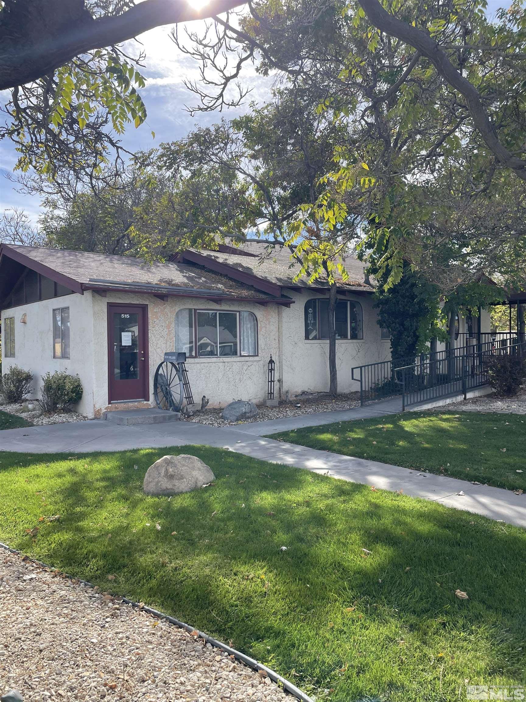 a view of a house with a yard and a patio