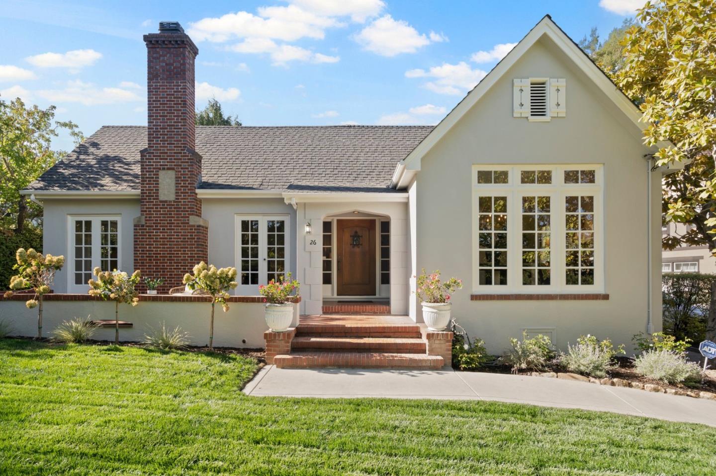 a front view of a house with a yard chairs