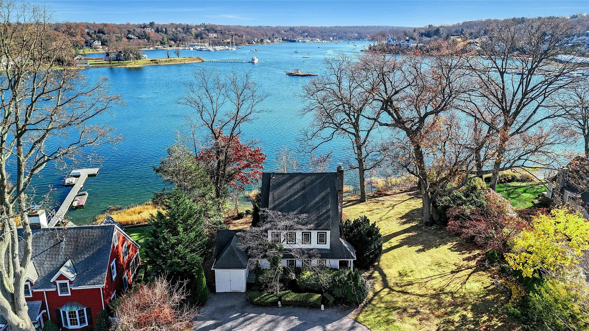 an aerial view of a house with a yard and lake view