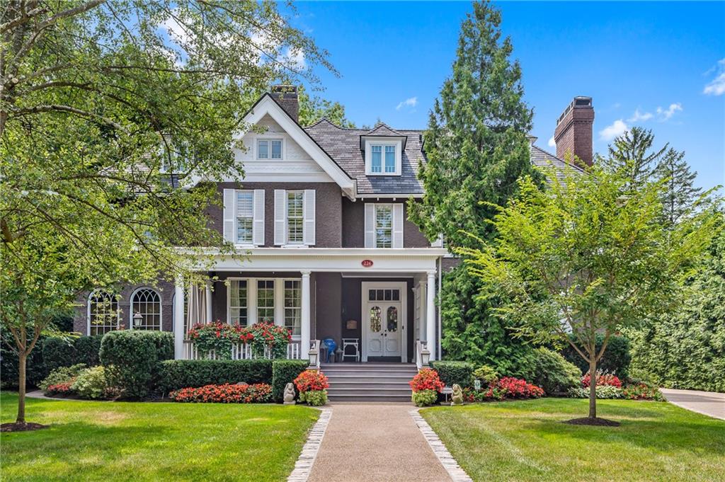 a front view of a house with garden and porch