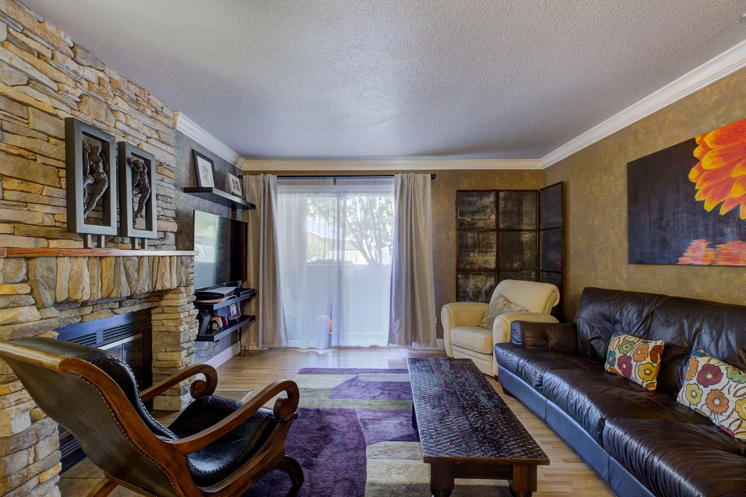 a living room with furniture fireplace and a flat screen tv