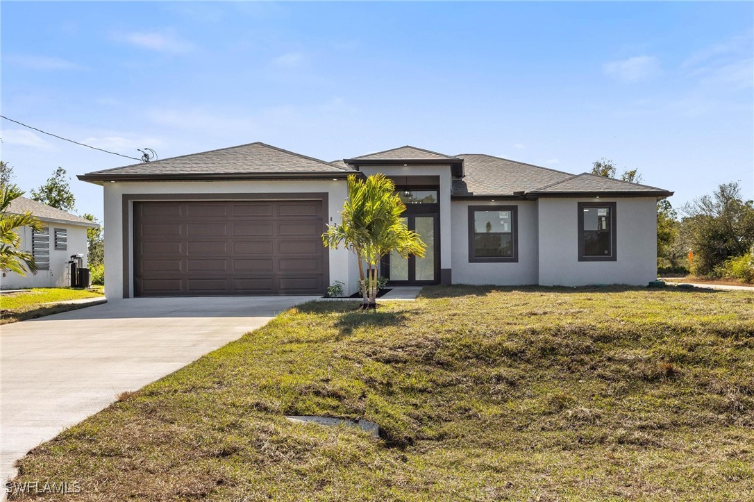 a front view of a house with a yard and garage