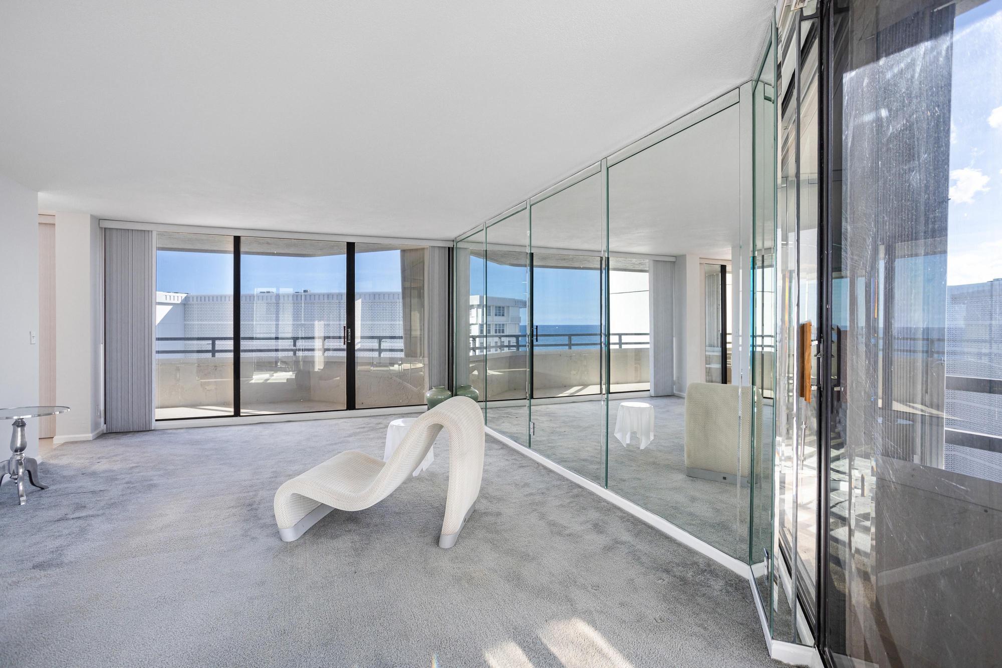 a living room with furniture and a floor to ceiling window