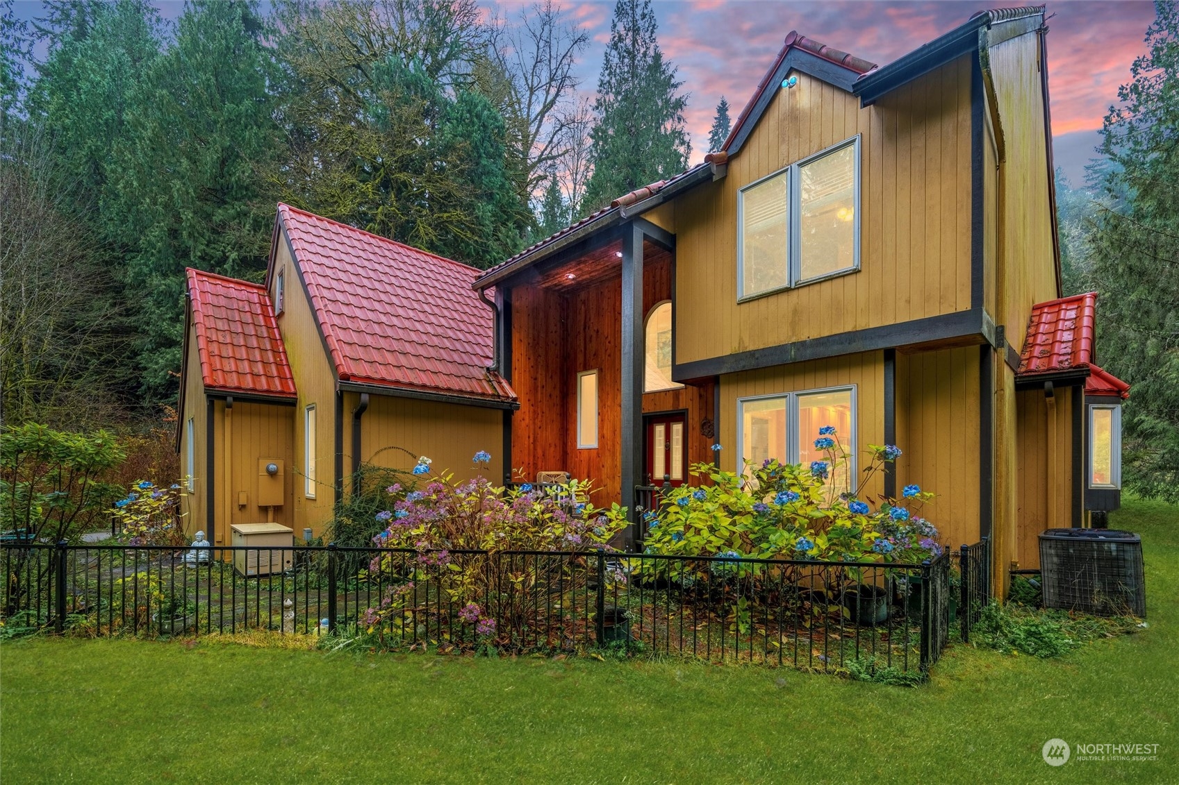 a front view of a house with a garden