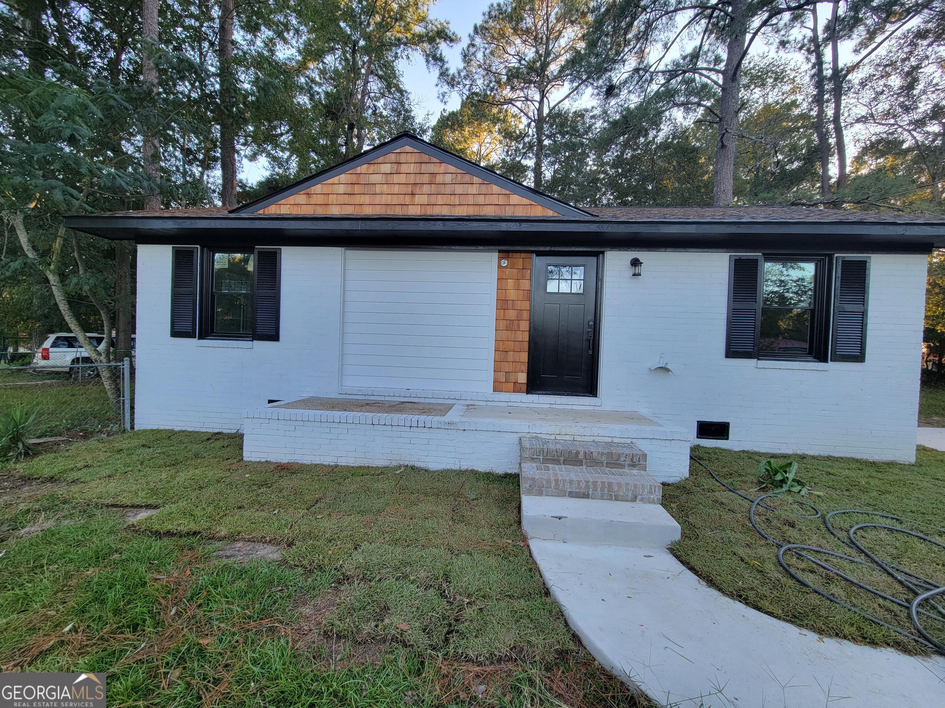 a front view of a house with garden