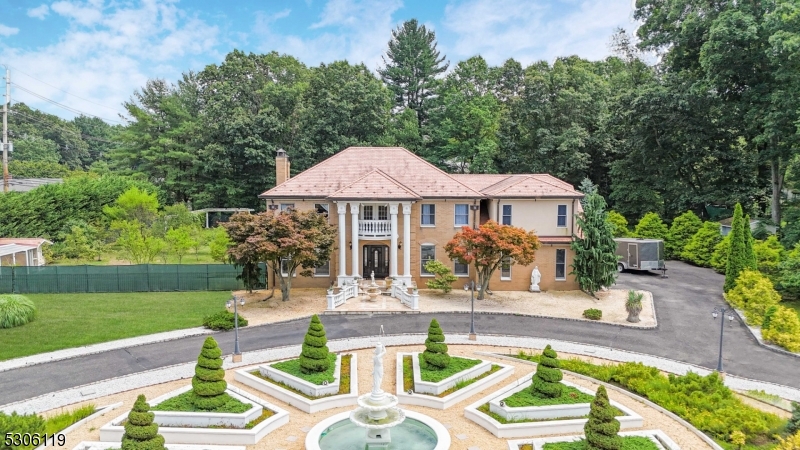 a front view of a house with garden and patio