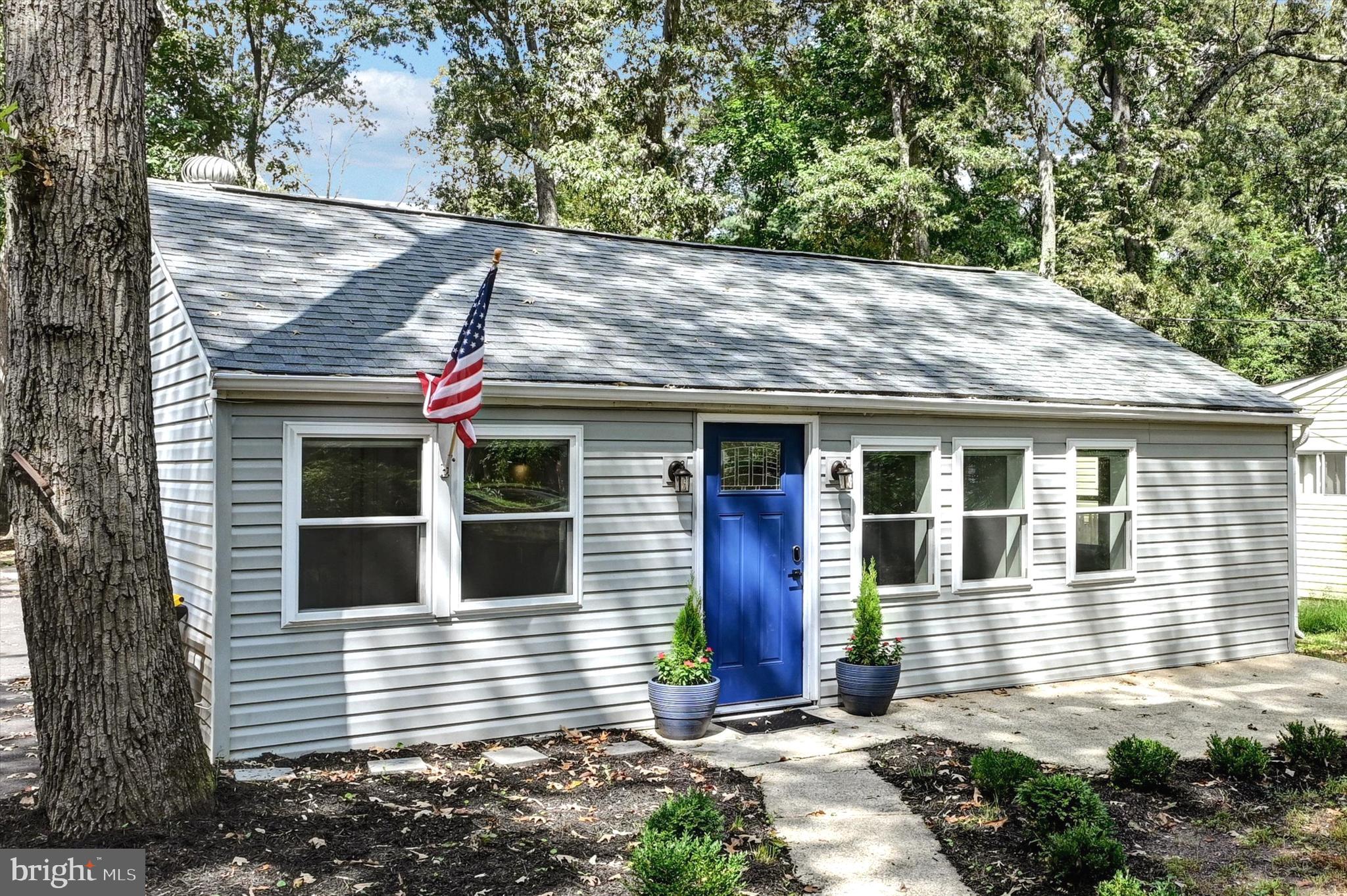 Front entry with concrete sidewalk and patio