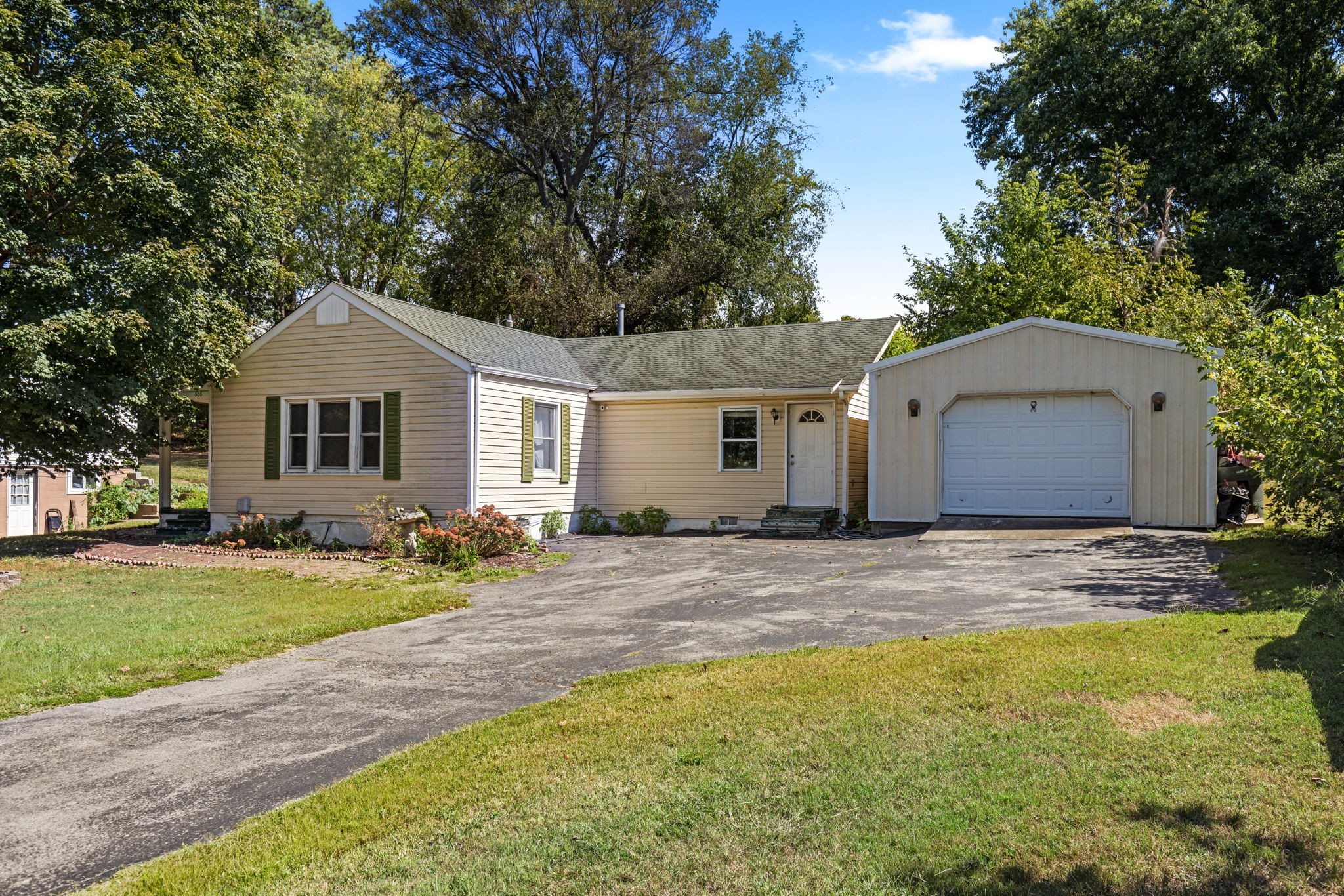 a front view of a house with a garden and patio