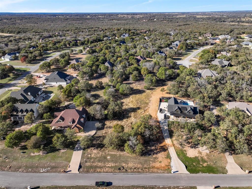 an aerial view of residential houses with city view