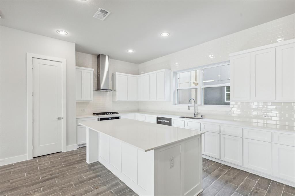 a kitchen with a sink stove and cabinets