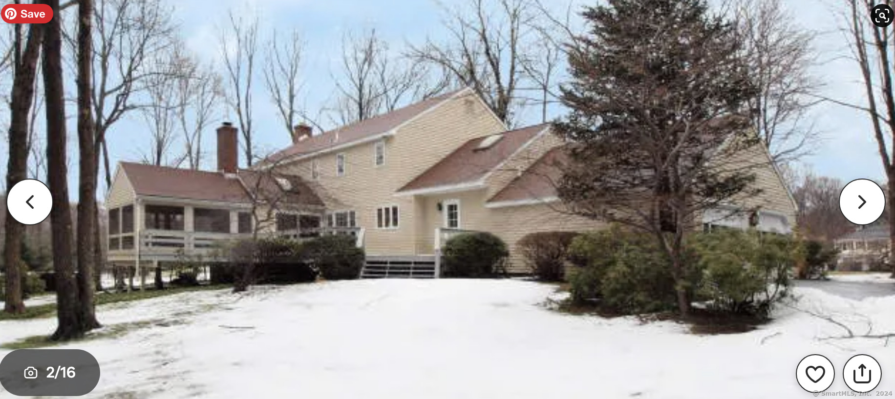 a view of a house with a yard covered in snow