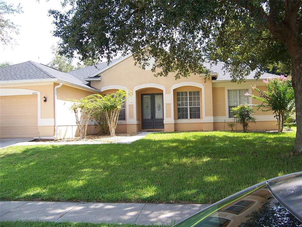 a front view of a house with a garden