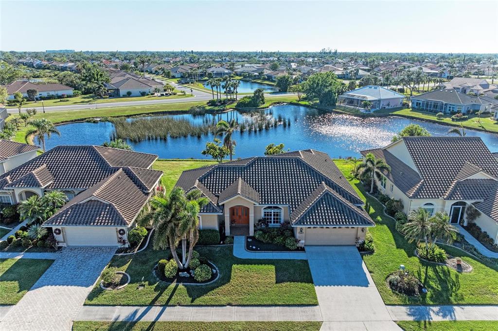 an aerial view of house with yard space and ocean view