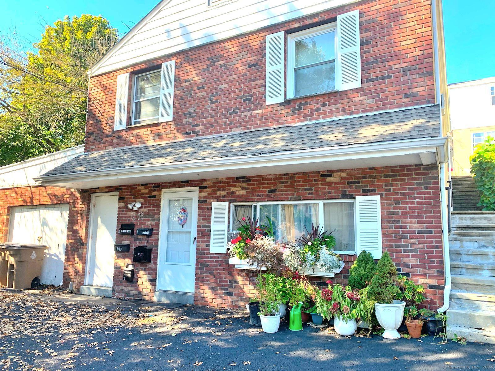 a front view of a building with potted plants