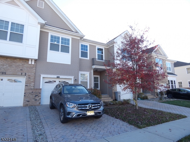 a car parked in front of a brick house