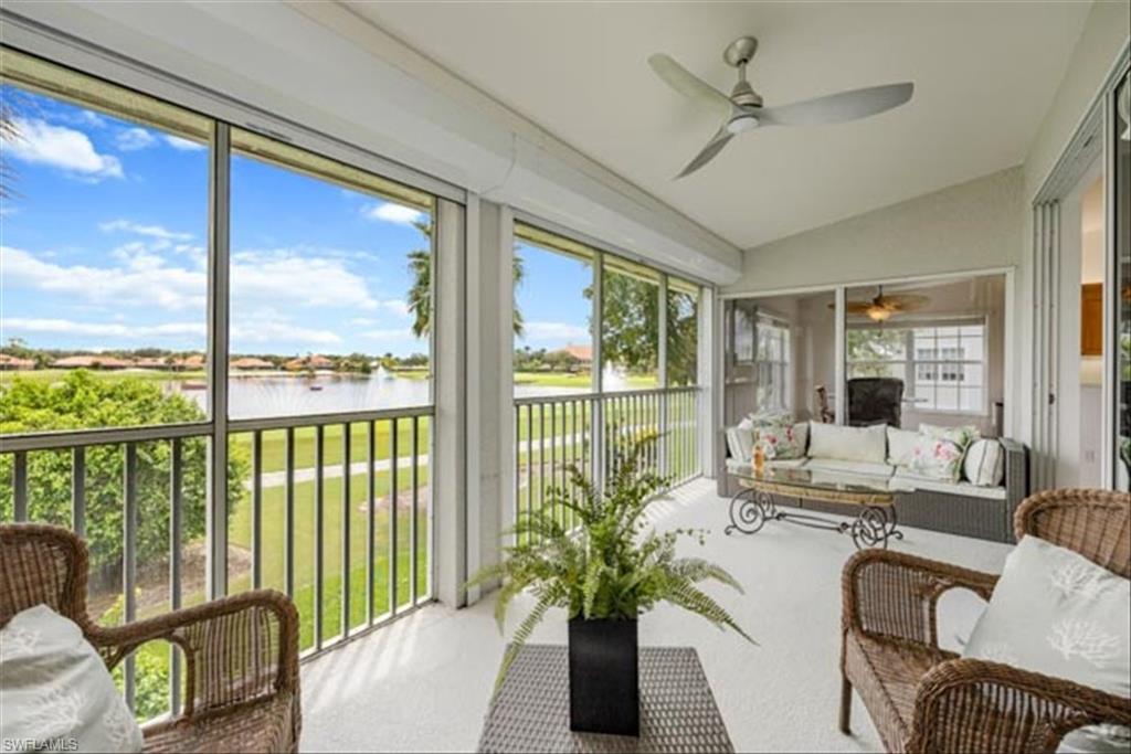 Sunroom / solarium with lofted ceiling, a wealth of natural light, a water view, and ceiling fan