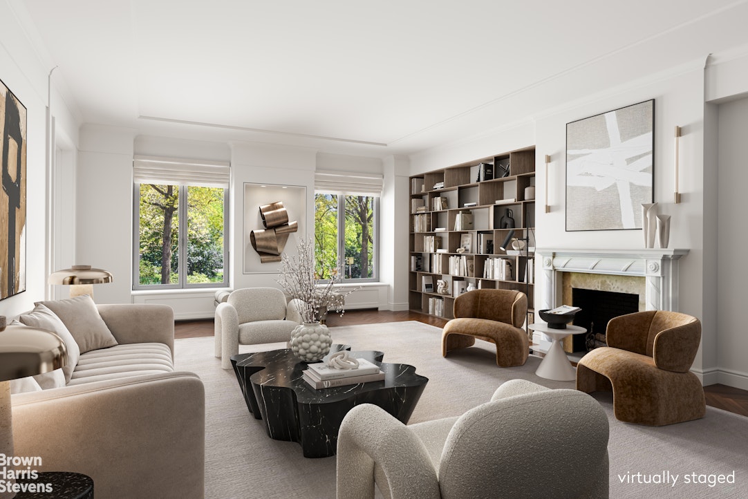 a living room with furniture fireplace and a large window