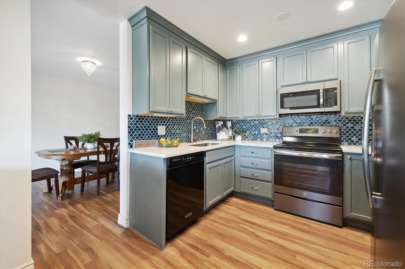 a kitchen with a refrigerator stove and sink