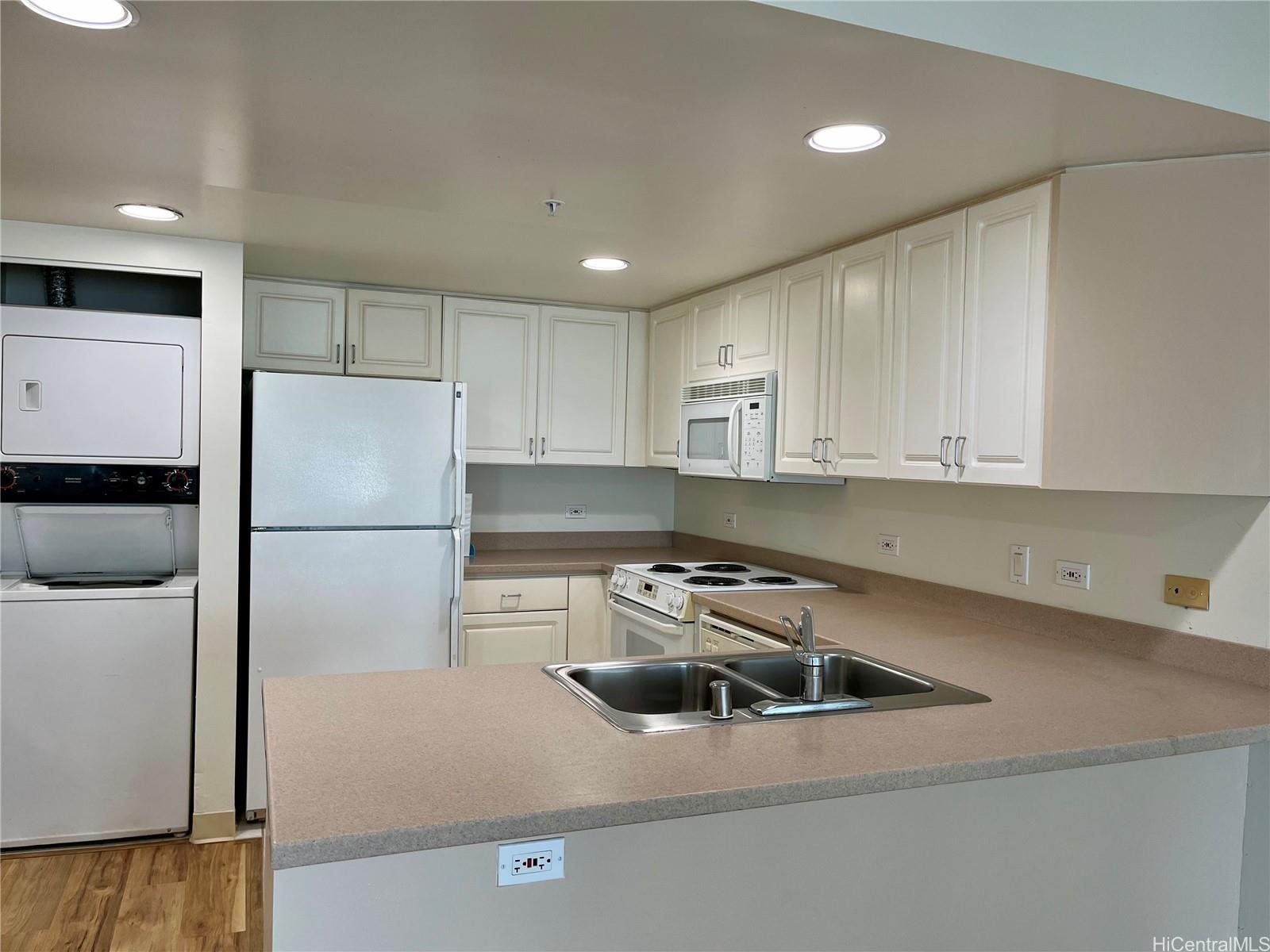 a kitchen with a refrigerator and a stove