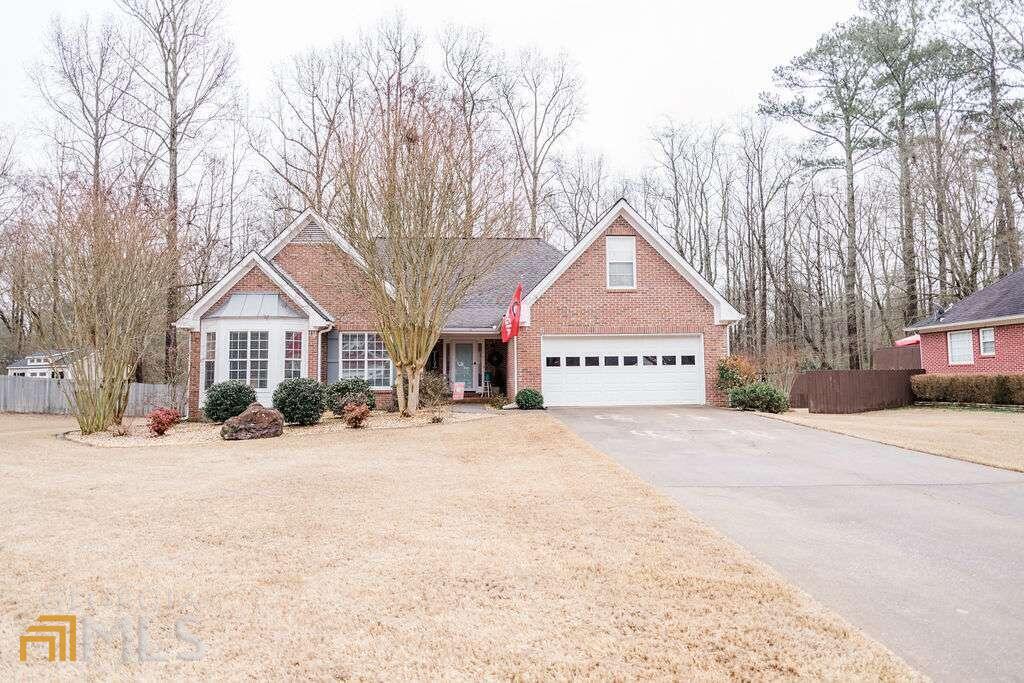 a front view of a house with a yard covered in snow