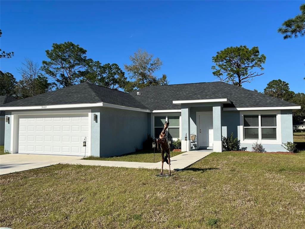 a front view of a house with a yard