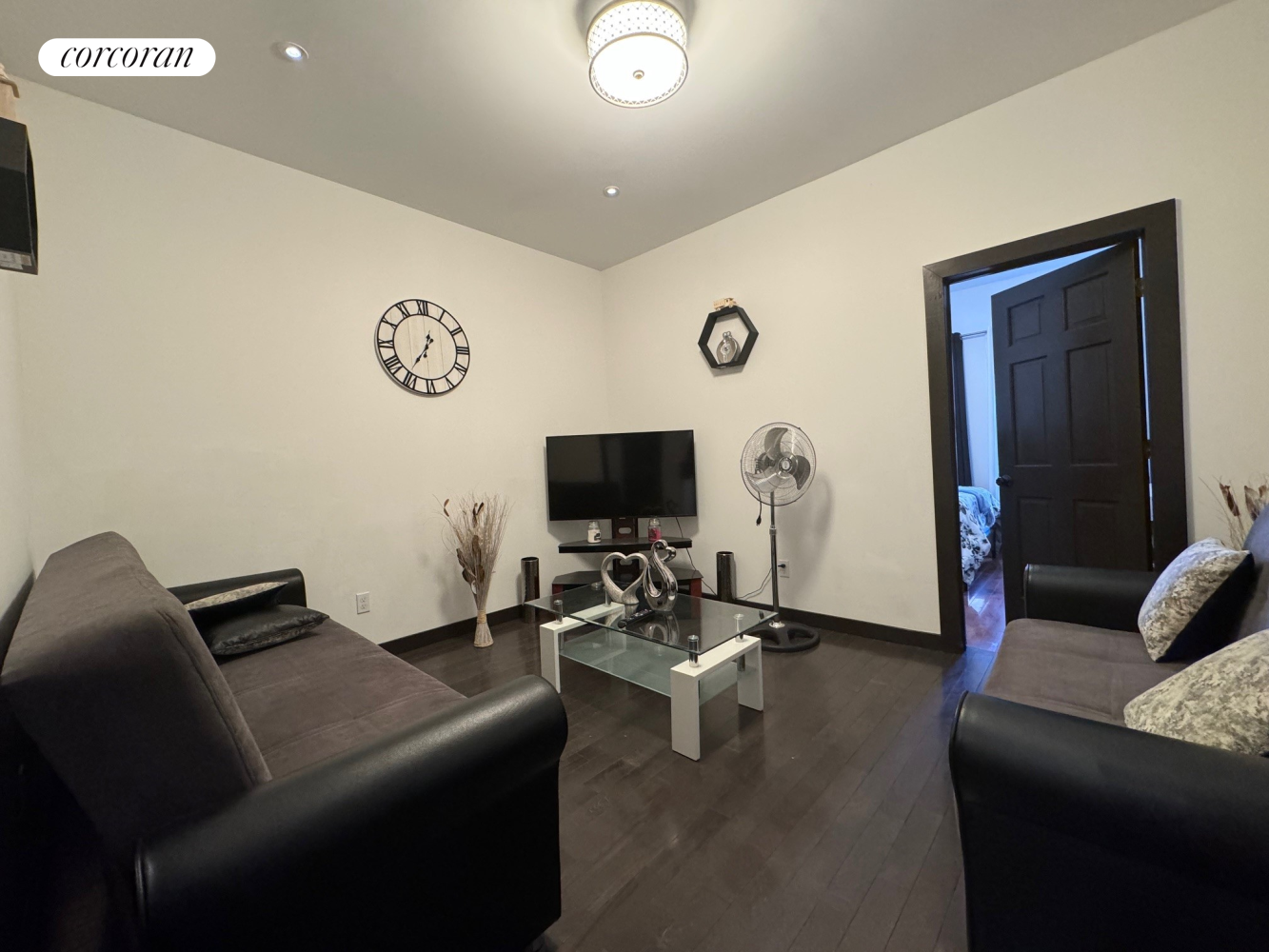 a living room with furniture and a flat screen tv