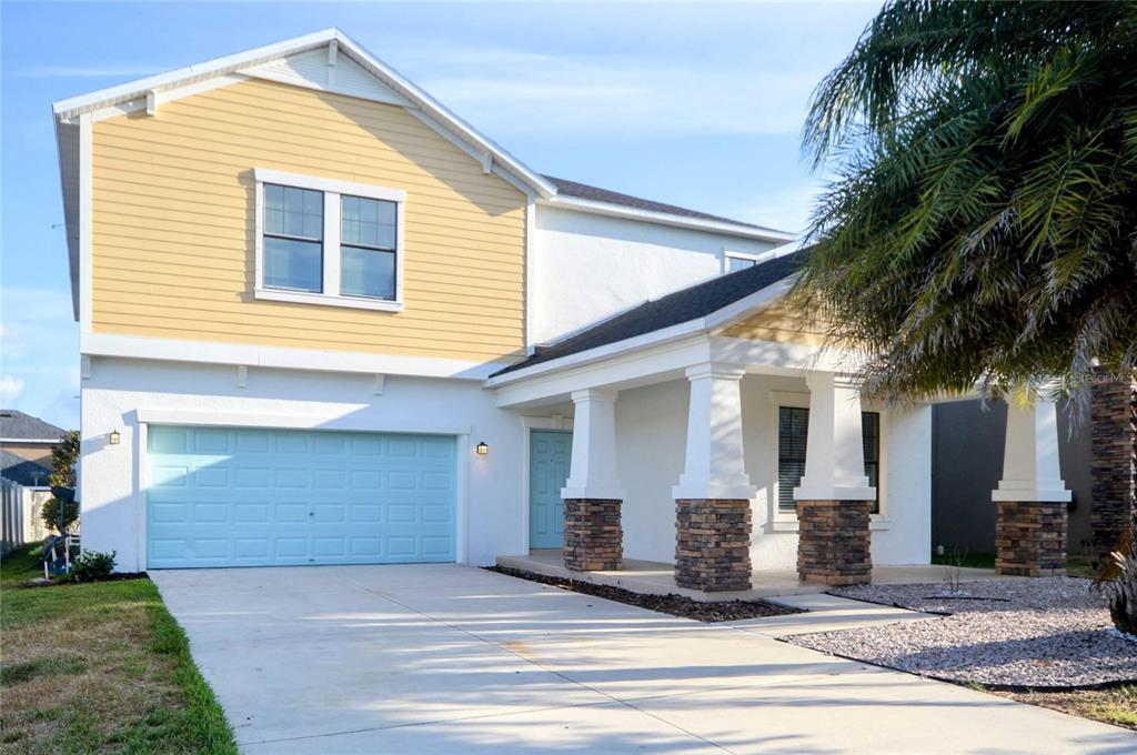 a front view of a house with garage