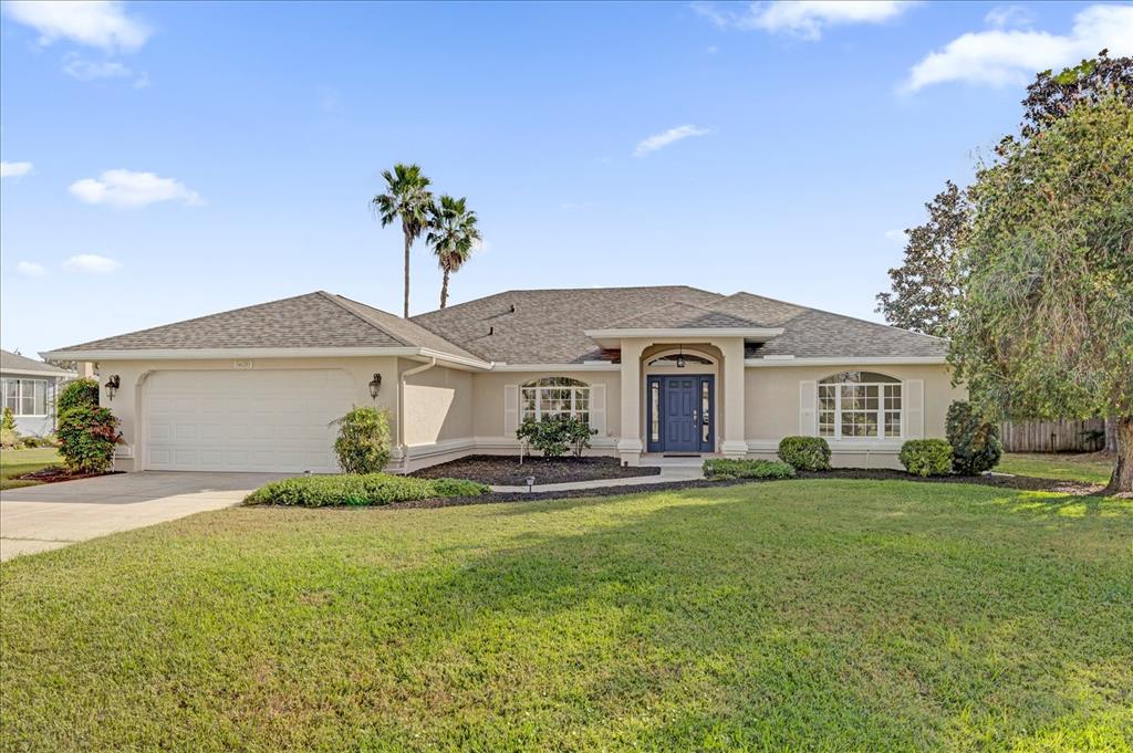 a front view of a house with a yard and garage