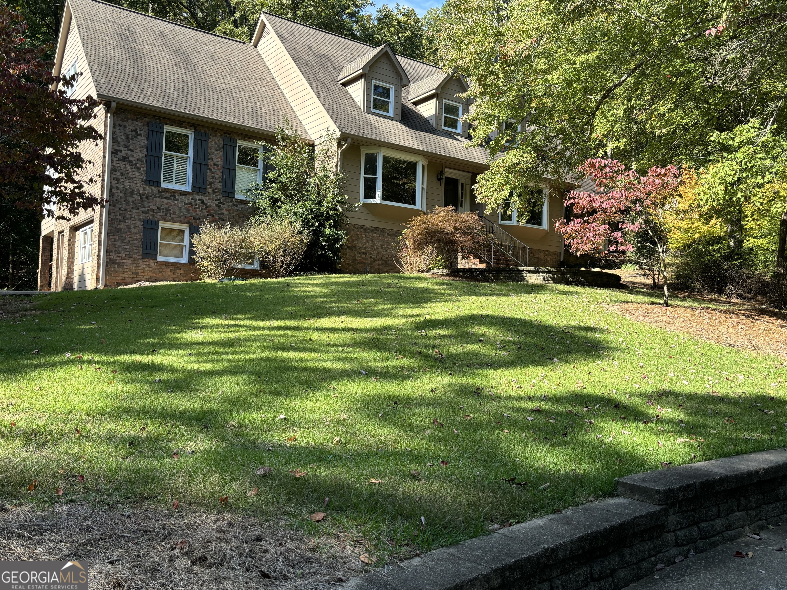 a front view of house with yard and green space