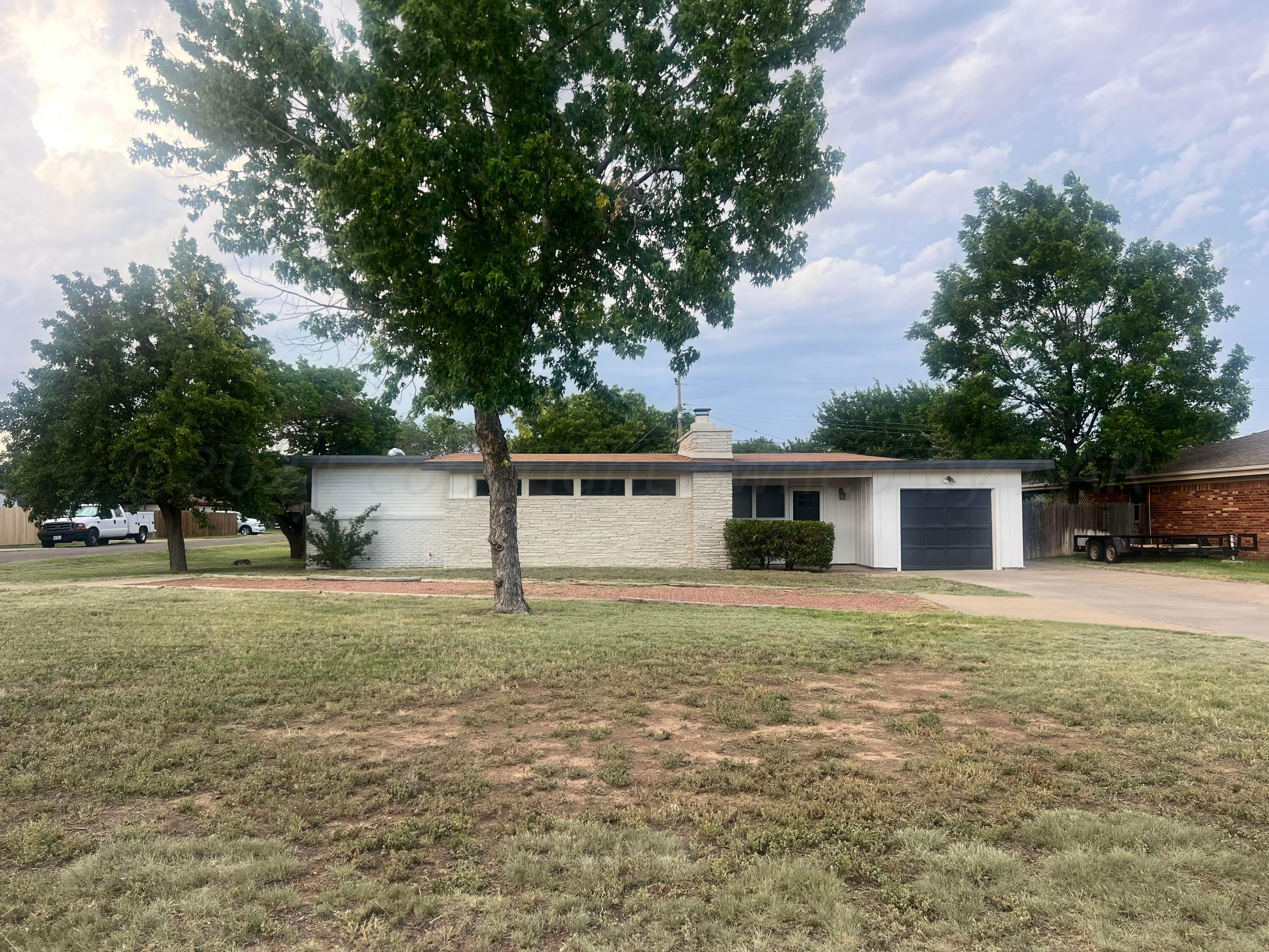 a house that has a tree in front of it